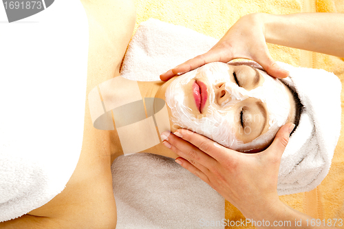 Image of young beautiful brunette woman doing wellness with massage