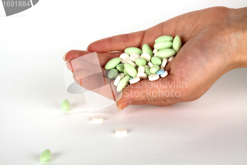 Image of left hand with pills for healthcare