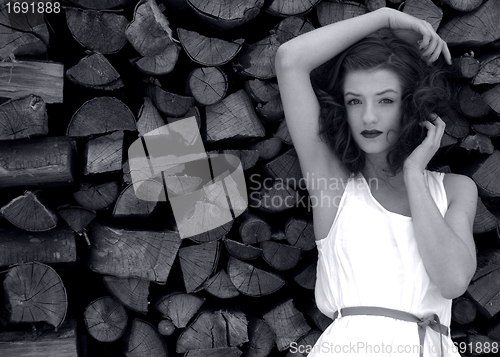 Image of young beatiful woman in fashion outdoor in front of wood black and white