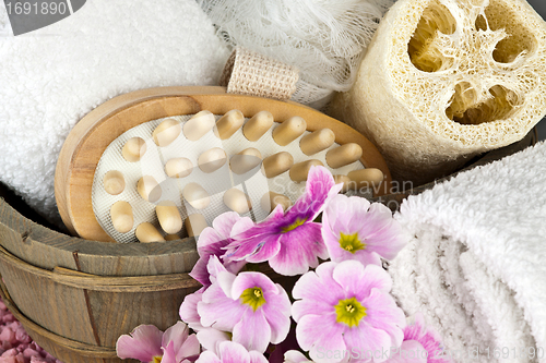 Image of pink flowers brush and sponge for wellness in a beauty spa