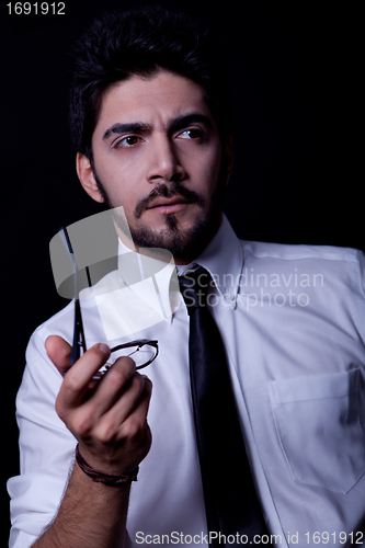 Image of young successful business man with a suit isolated on black background