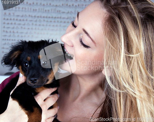 Image of young beatiful girl with a cute little dog having fun