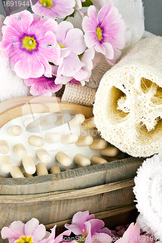 Image of pink flowers brush and sponge for wellness in a beauty spa