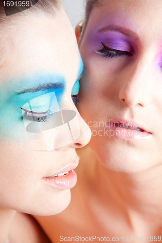 Image of young beautiful woman with an extreme colorfull make up portrait
