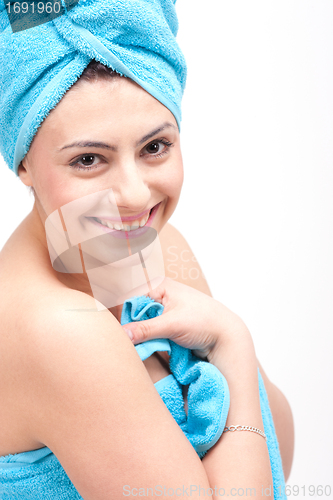 Image of young beautiful woman with a towel doing wellness