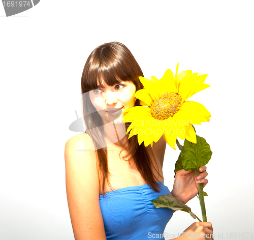 Image of young beautiful brunette woman with a flower happy