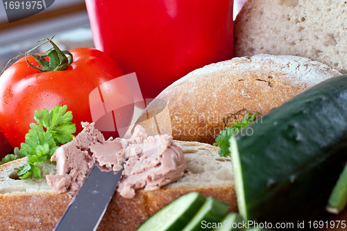 Image of breakfast or lunch with mixed vegetables, sausage and a knife