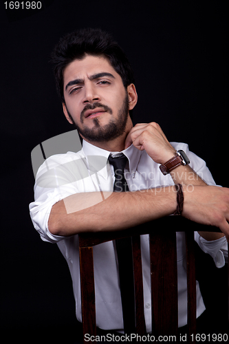 Image of young successful business man with a suit isolated on black background