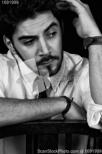 Image of young successful business man with a suit isolated on black background