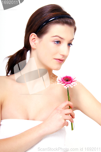 Image of young beautiful brunette woman with flower