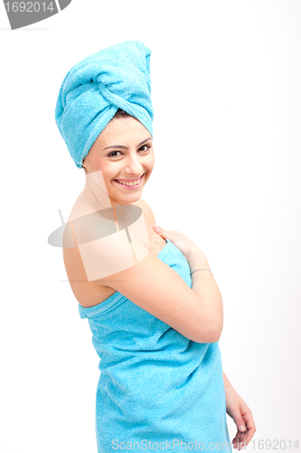 Image of young beautiful woman with a towel doing wellness
