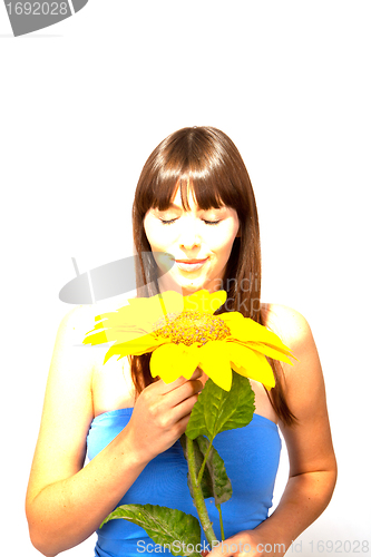 Image of young beautiful brunette woman with a flower happy