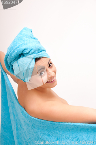 Image of young beautiful woman with a towel doing wellness