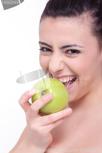 Image of beautiful young brunette girl with a green apple 