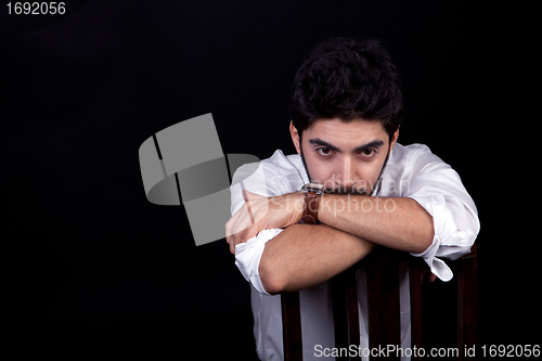 Image of young successful business man with a suit isolated on black background