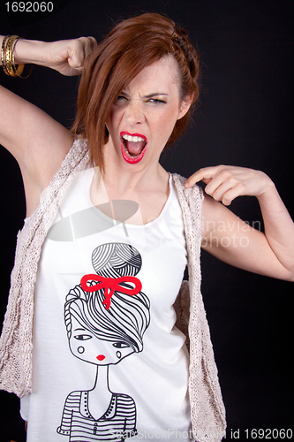 Image of portrait of a beautiful young woman with red hair and red lips