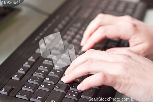 Image of womans hand on a coumputer keyboard