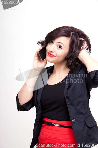 Image of young business woman is talking on the mobile phone