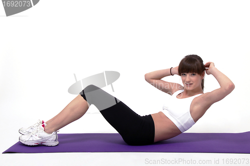 Image of young beuatiful woman is doing workout 