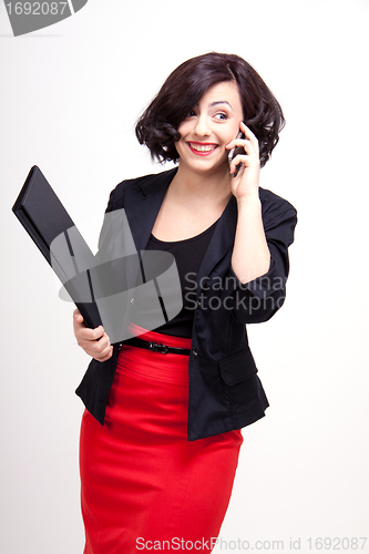 Image of young business woman is talking on the mobile phone