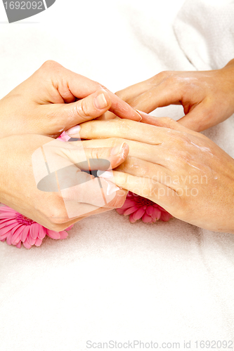 Image of feminin hands with a treatment doing a manicure closeup