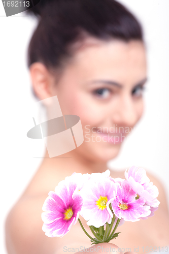 Image of young beautiful brunette woman with flower
