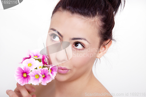 Image of young beautiful brunette woman with flower