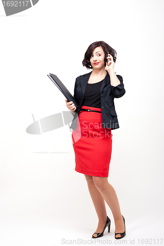 Image of young business woman is talking on the mobile phone