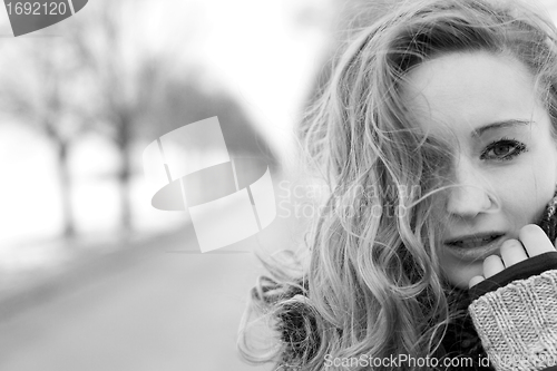 Image of young woman outside in winter in snow cold