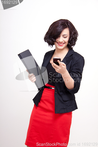 Image of young business woman is talking on the mobile phone