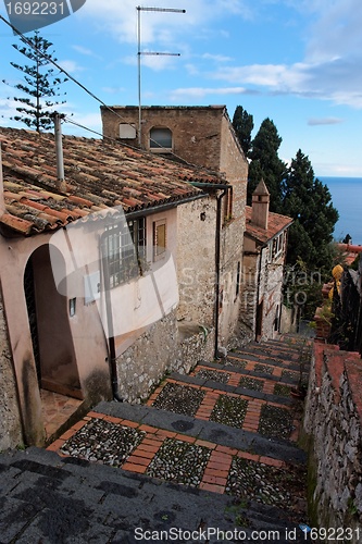 Image of Small street in Sicilian town of Taormina descending toward the sea 