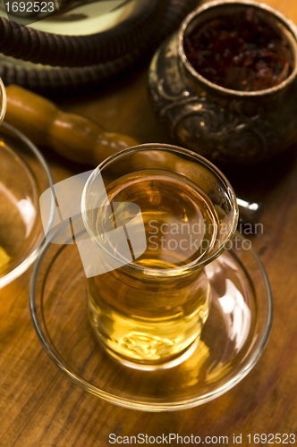 Image of Cup of turkish tea and hookah served in traditional style