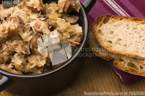 Image of traditional polish sauerkraut (bigos) with mushrooms and plums