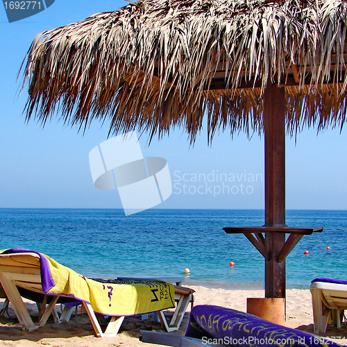 Image of Sunchairs and umbrellas on Beach