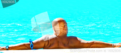Image of  Big man relax in swimming pool
