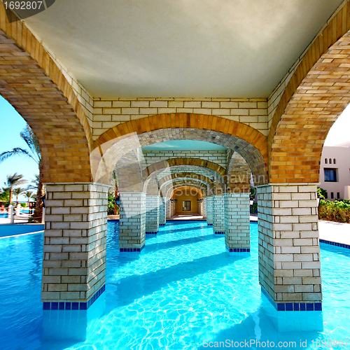 Image of  Swimming pool under bridge in resort