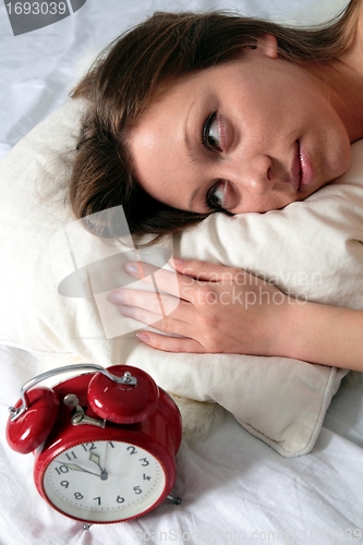 Image of Woman awake with alarm clock