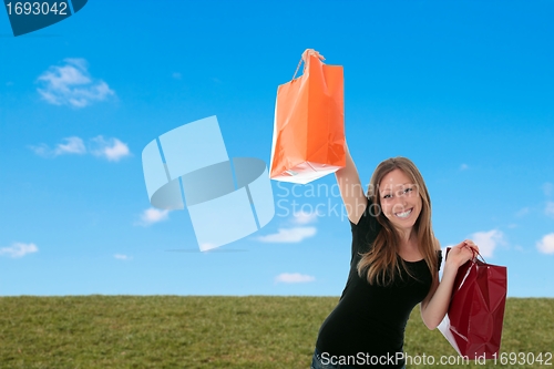 Image of Woman with shopping bags outside