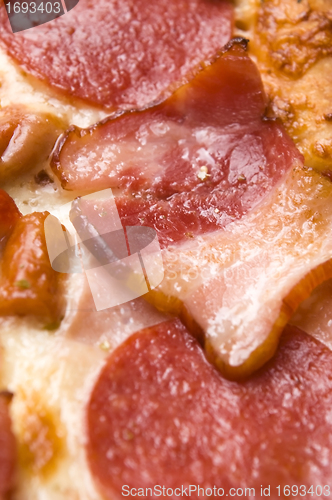 Image of Italian pizza with bacon, salami and mozzarella cheese