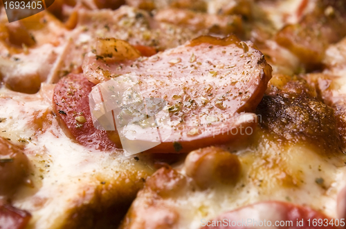 Image of Italian pizza with bacon, salami and mozzarella cheese