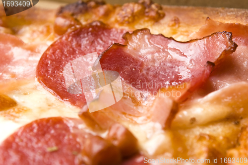 Image of Italian pizza with bacon, salami and mozzarella cheese