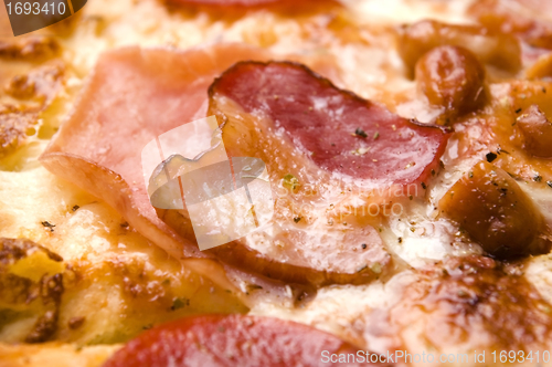 Image of Italian pizza with bacon, salami and mozzarella cheese