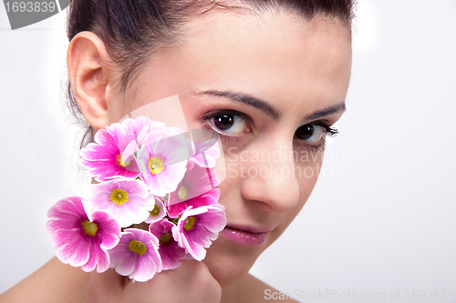 Image of young beautiful brunette woman with flower