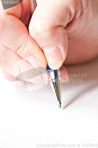 Image of womans hand is writing a letter with a pen 