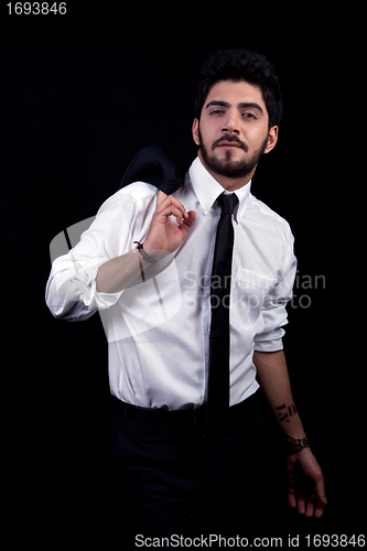 Image of young successful business man with a suit isolated on black background