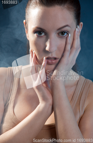 Image of young beautiful woman with an extreme colorfull make up portrait