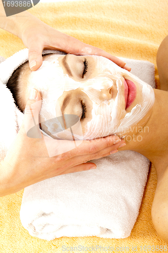 Image of young beautiful brunette woman doing wellness with massage