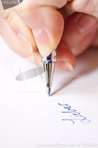 Image of womans hand is writing a letter with a pen 