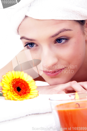 Image of young beautiful woman with a towel doing wellness