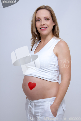 Image of older pregnant woman looks forward to her baby